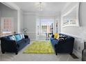 Inviting living room features modern sofas, a vibrant green rug, and plenty of natural light at 1286 Creekside Se Ter, Smyrna, GA 30082