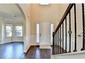 Bright foyer with high ceilings, dark wood floors, and traditional wainscoting at 1465 Forest Brook Trl, Cumming, GA 30041