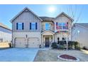 Charming two-story home featuring a well-manicured lawn, two-car garage, and inviting front entrance at 1465 Forest Brook Trl, Cumming, GA 30041
