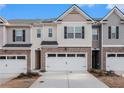 Attractive townhome featuring a two-car garage and appealing architectural details at 1026 King Iron Dr, Lawrenceville, GA 30045