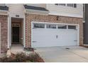 Attached two-car garage and front door at 1026 King Iron Dr, Lawrenceville, GA 30045