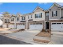 Street view of townhomes with garages and landscaping at 1026 King Iron Dr, Lawrenceville, GA 30045