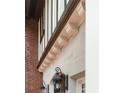Architectural detail showcasing decorative corbels, an exterior light fixture, and a brick wall at 1585 S Ponce De Leon Avenue #M3, Atlanta, GA 30307
