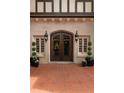 Elegant front entrance featuring a double wood door, sconces, and manicured planters on a brick landing at 1585 S Ponce De Leon Avenue #M3, Atlanta, GA 30307
