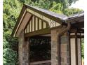 Covered stone patio detail highlighting the stonework, the roofline and the surrounding lush landscaping at 1585 S Ponce De Leon Avenue #M3, Atlanta, GA 30307