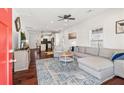 Bright and airy living room featuring hardwood floors, a large sectional, and an open layout connecting to the kitchen at 2599 Church Nw St, Atlanta, GA 30318