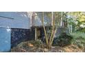 Blue home with a covered porch and boarded windows, showing the property's renovation potential at 1775 Hadlock Sw St, Atlanta, GA 30311