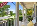 Inviting front porch with white railings and a cozy seating area overlooking the neighborhood at 3460 Trow Creek Ln, Cumming, GA 30040