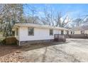 Exterior view of a home with a small backyard and a wooden fence at 114 Howell Sw Dr, Atlanta, GA 30331