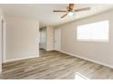 Bright living room featuring sleek gray flooring, neutral walls, and a ceiling fan at 114 Howell Sw Dr, Atlanta, GA 30331