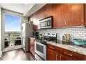 Bright modern kitchen featuring stainless steel appliances, granite counters, and a window with an amazing outdoor view at 565 Peachtree St # 1311, Atlanta, GA 30308
