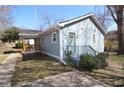 Charming exterior view showcasing the home's light blue siding, well-maintained lawn, and inviting front porch at 127 Marona Ne St, Atlanta, GA 30307
