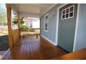Inviting front porch featuring wooden floors and railing, with a charming light blue exterior and a green front door at 127 Marona Ne St, Atlanta, GA 30307