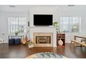 Bright living room featuring a stone fireplace, hardwood floors, and large windows at 3302 Heritage Walk Ln, Duluth, GA 30096