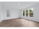 Bright bedroom with hardwood floors, modern window, and abundant natural light at 484 Hammons Way, Atlanta, GA 30315