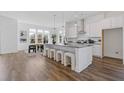 Spacious kitchen featuring a large island with seating and modern pendant lighting at 484 Hammons Way, Atlanta, GA 30315