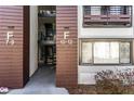 Close up of condo entrance showing unit numbers, natural lighting, and exterior walkway at 1445 Monroe Ne Dr # F12, Atlanta, GA 30324