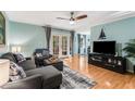 Cozy living room with hardwood floors, gray sofa set, and glass doors to the outside at 1445 Monroe Ne Dr # F12, Atlanta, GA 30324