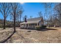 A single-story home showcasing a cozy covered front porch and mature trees on a sunny day at 459 Rabbit Run, Mcdonough, GA 30252