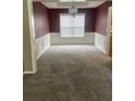 Dining room features a textured accent wall, carpet and white wainscoting at 7597 Cole Ln, Atlanta, GA 30349