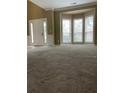 Spacious living room featuring neutral paint, carpeted floor and lots of natural light at 7597 Cole Ln, Atlanta, GA 30349