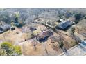 An aerial view of a home with large yard, adjacent streets, and other homes in the neighborhood at 1141 Milstead Ne Ave, Conyers, GA 30012