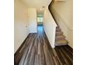 Inviting foyer with wood flooring, a staircase, and a glimpse into the bright living area at 206 Gillis Sw Way, Villa Rica, GA 30180