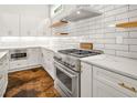 Bright kitchen featuring white cabinets, stainless steel appliances, and stylish hardware at 244 Locust Ne St # B, Atlanta, GA 30317