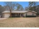 Charming ranch-style home with metal roof and well-manicured lawn, perfect for suburban living at 4775 Hemlock Se Dr, Conyers, GA 30094