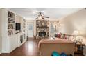 Cozy living room with stone fireplace, built-in shelving, and hardwood floors, great for relaxing at 4775 Hemlock Se Dr, Conyers, GA 30094