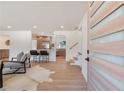 Bright, open-concept living room flowing into the kitchen, featuring hardwood floors at 3401 Lori Ln, Atlanta, GA 30340