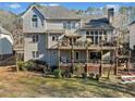 View of the back of the house showing a multi-level deck and backyard with green space at 735 Amberton Close, Suwanee, GA 30024