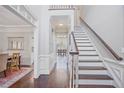 Inviting foyer with hardwood floors, staircase, and views into dining and other living spaces at 1835 Berkeley Ne Mews, Atlanta, GA 30329