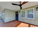 Inviting covered porch featuring wood flooring, ceiling fan, and a secure front entry at 543 Paines Nw Ave, Atlanta, GA 30318