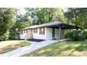 Charming exterior view of a home with a covered parking area and well-maintained landscaping at 1300 Wichita Sw Dr, Atlanta, GA 30311