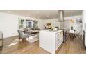 Open-concept living room and kitchen with hardwood floors, stainless steel appliances and ample natural light at 1300 Wichita Sw Dr, Atlanta, GA 30311