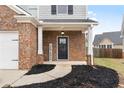 Inviting front porch with brick columns, a stylish front door, and decorative landscaping at 14 Old Hemlock Nw Cv, Cartersville, GA 30121