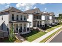 Attractive street view of new construction homes with inviting front porches and well-manicured lawns at 167 Basil Street, Cumming, GA 30040