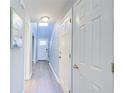 Inviting hallway with light blue walls, hardwood floors and a well-lit front door, creating a warm and welcoming entrance at 3721 Stonewall Se Cir, Atlanta, GA 30339