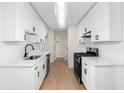 Modern kitchen boasts white cabinets, stainless steel appliances, and sleek countertops at 2966 Knollberry Ln, Decatur, GA 30034