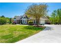 Well-kept home on sprawling lawn featuring attached garage, mature trees, and long driveway at 815 Spring View Ct, Covington, GA 30014