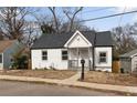Charming bungalow featuring a fresh white paint scheme and a well-manicured lawn at 1104 Oak Knoll Se Ter, Atlanta, GA 30315