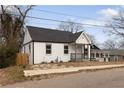 Bungalow featuring a fresh white paint scheme, dark roof, and a small front yard at 1104 Oak Knoll Se Ter, Atlanta, GA 30315