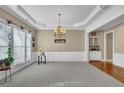 Elegant dining room with large windows, crown molding, and decorative chandelier at 1460 Badingham Dr, Cumming, GA 30041