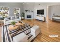 Bright living room features hardwood floors, a cozy fireplace, and large windows that let in plenty of natural light at 3284 Roundfield Cir, Duluth, GA 30096