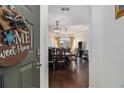 Chandelier lit dining room with wood floors visible from entry way at 400 17Th Nw St # 2427, Atlanta, GA 30363