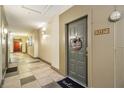 Hallway view showcasing apartment door with decor and tiled floors at 400 17Th Nw St # 2427, Atlanta, GA 30363
