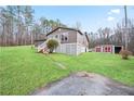 This home features a well-kept yard and convenient storage sheds on a spacious lot at 209 Sweetwater Trl, Villa Rica, GA 30180