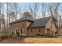 Two-story brick home with attached garage, tidy lawn, and an American flag at 3542 Jefferson Township Pkwy, Marietta, GA 30066