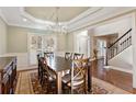 Elegant dining room featuring hardwood floors, a chandelier, decorative molding and views into the foyer at 4095 Oberon Se Ct, Smyrna, GA 30080